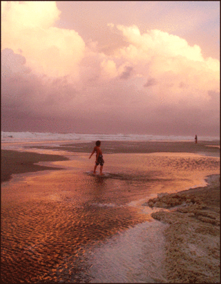 A boy with his skimboard
